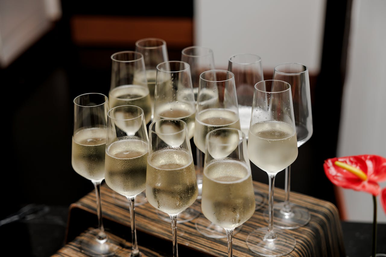 Close-up of filled champagne glasses on a tray, perfect for celebrations and events.
